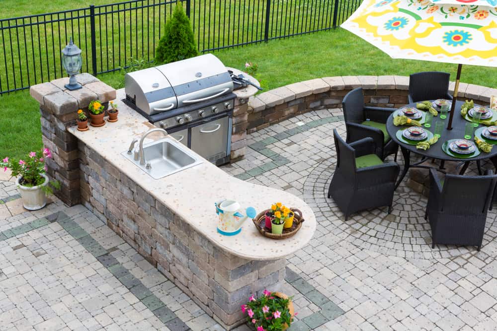 outdoor kitchen built into a stone patio