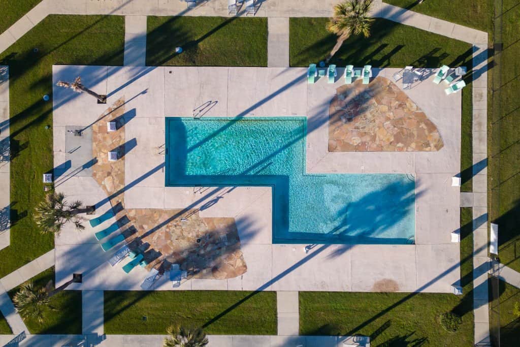 a custom inground swimming pool with two rectangular sections connected in the middle